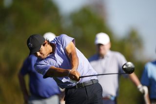 Charlie Woods strikes a tee shot with his driver