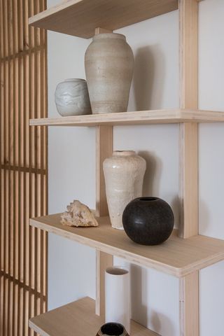 Crystals placed on a shelf with different vases