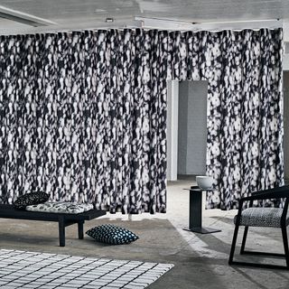 black and white curtain cushions and black bench