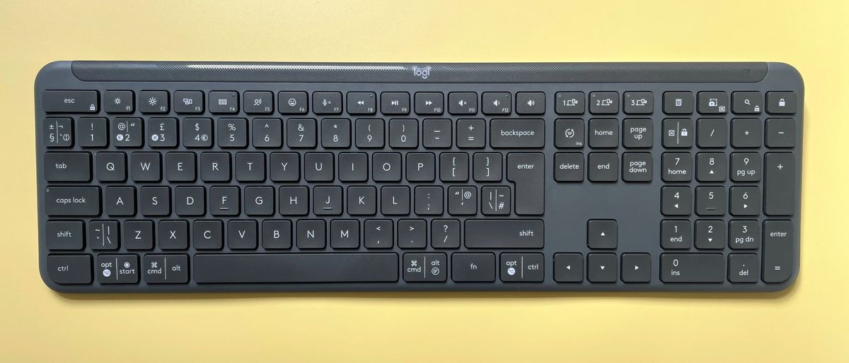 The Logitech Signature Slim K950 wireless keyboard against a yellow background.