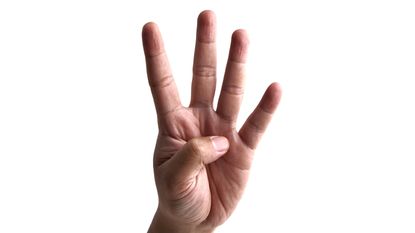 A hand with four fingers held up to represent the number four.