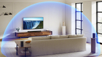 The Sony Bravia Theatre Bar 7 suundbar pictured beneath a TV in a living room. A blue dome illustrates the Dolby Atmos sound reproduction.