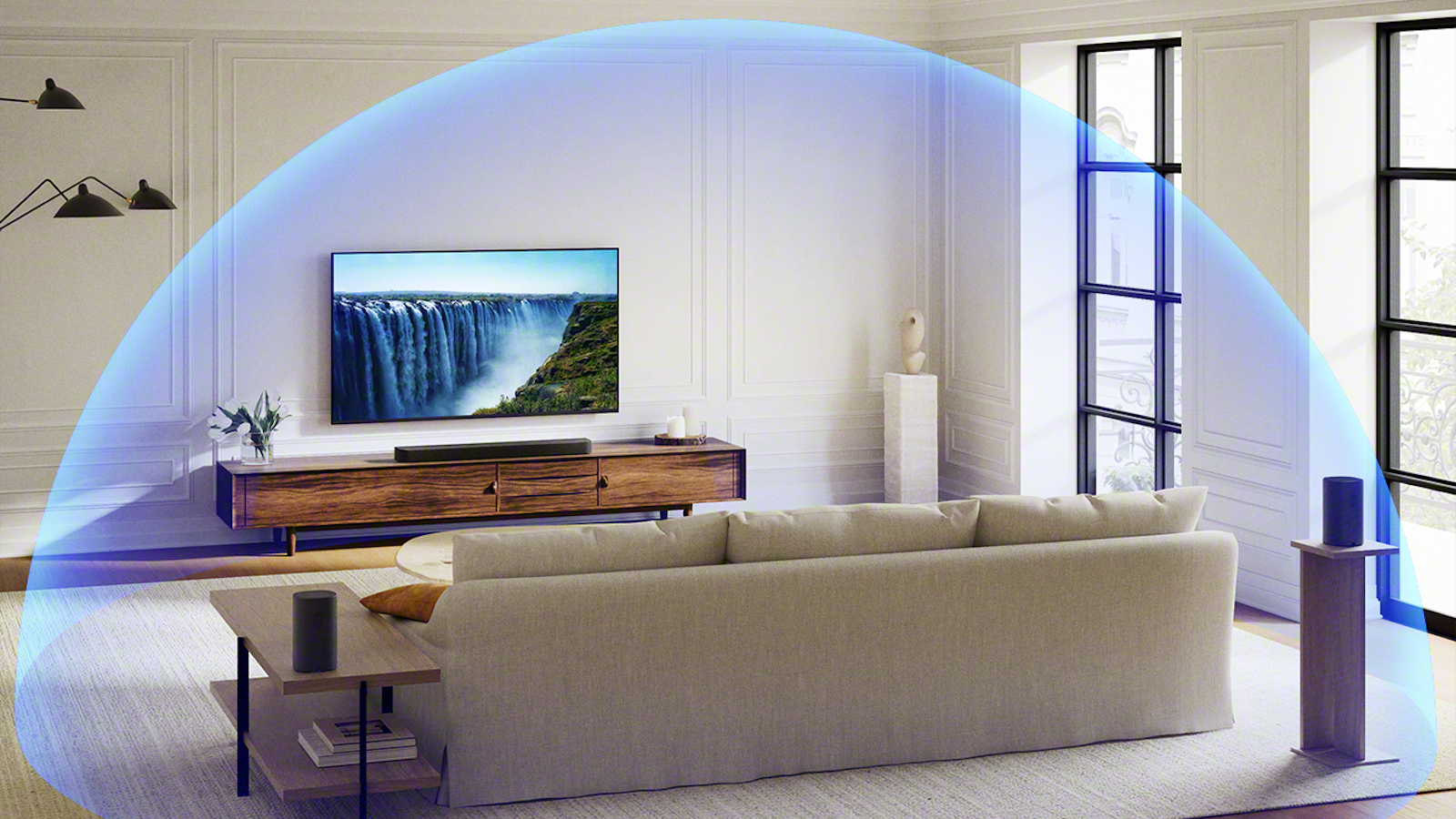 The Sony Bravia Theatre Bar 7 suundbar pictured beneath a TV in a living room. A blue dome illustrates the Dolby Atmos sound reproduction.