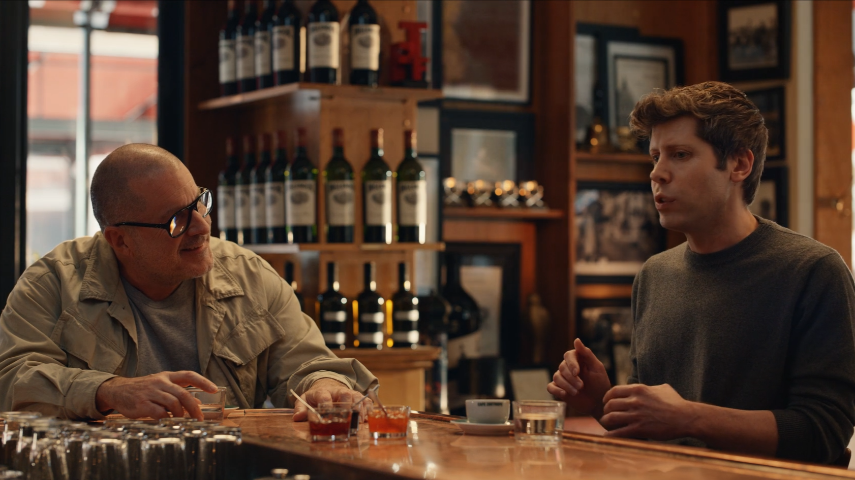 Jony Ive and OpenAI&#039;s Sam Altman talking about a new AI company at a bar