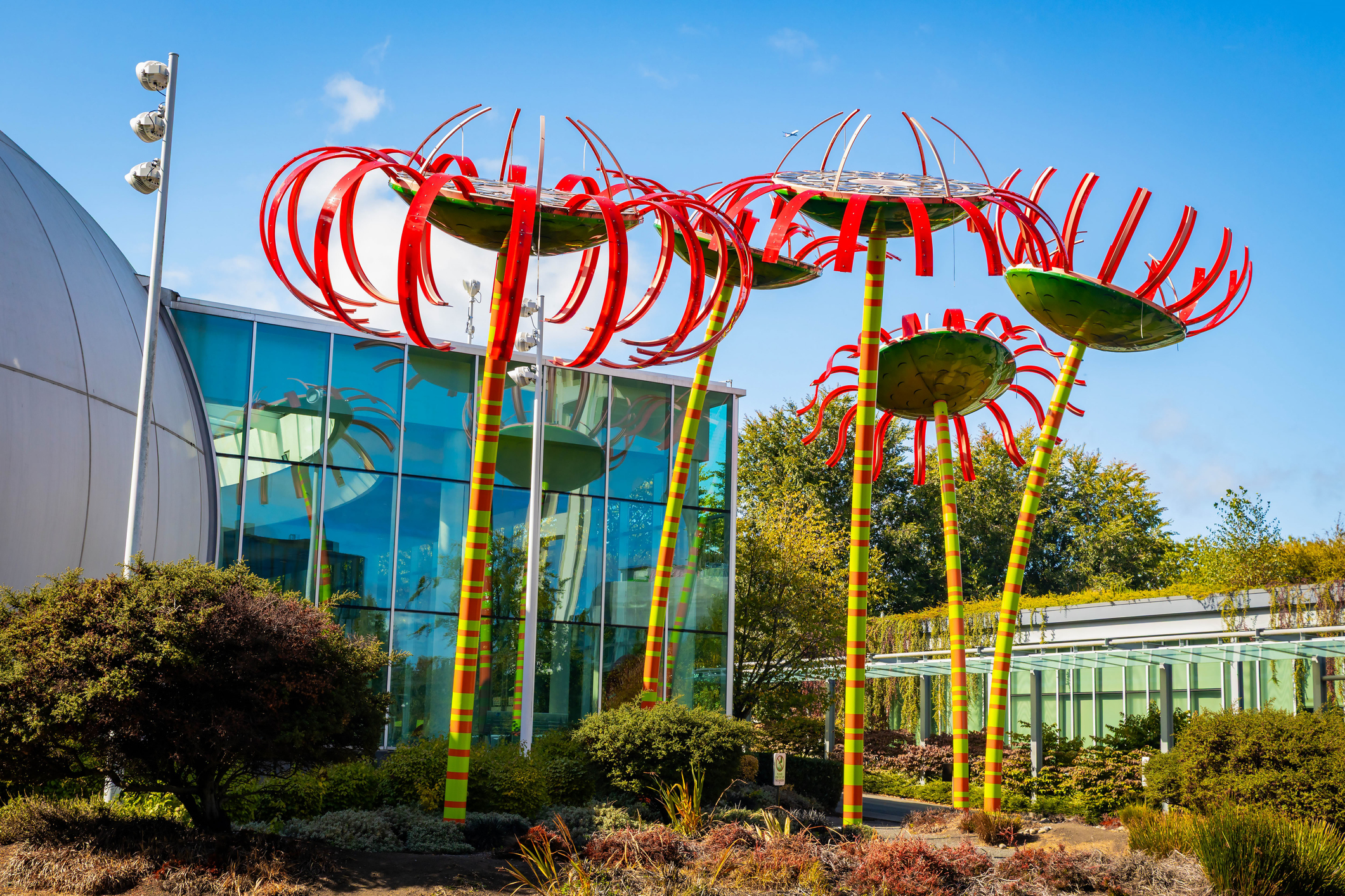 Seattle, WA, USA - September 21, 2025: The vibrant, intricate glass sculptures of the Chihuly Garden and Glass exhibition are displayed outdoors amidst the lush greenery of the Seattle gardens.