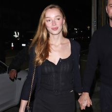 Phoebe Dynevor wears black pants 