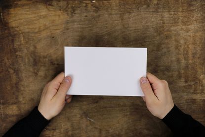A man holds a note card.