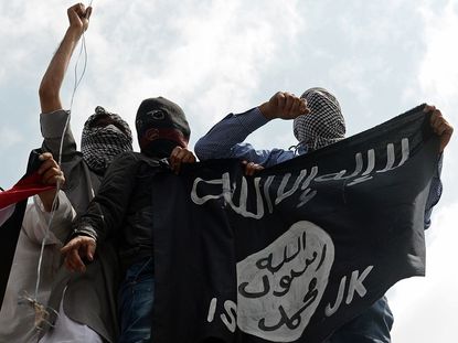 Demonstrators holding up the Islamic State flag