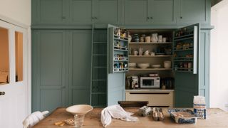 grey green full height kitchen units with larder unit