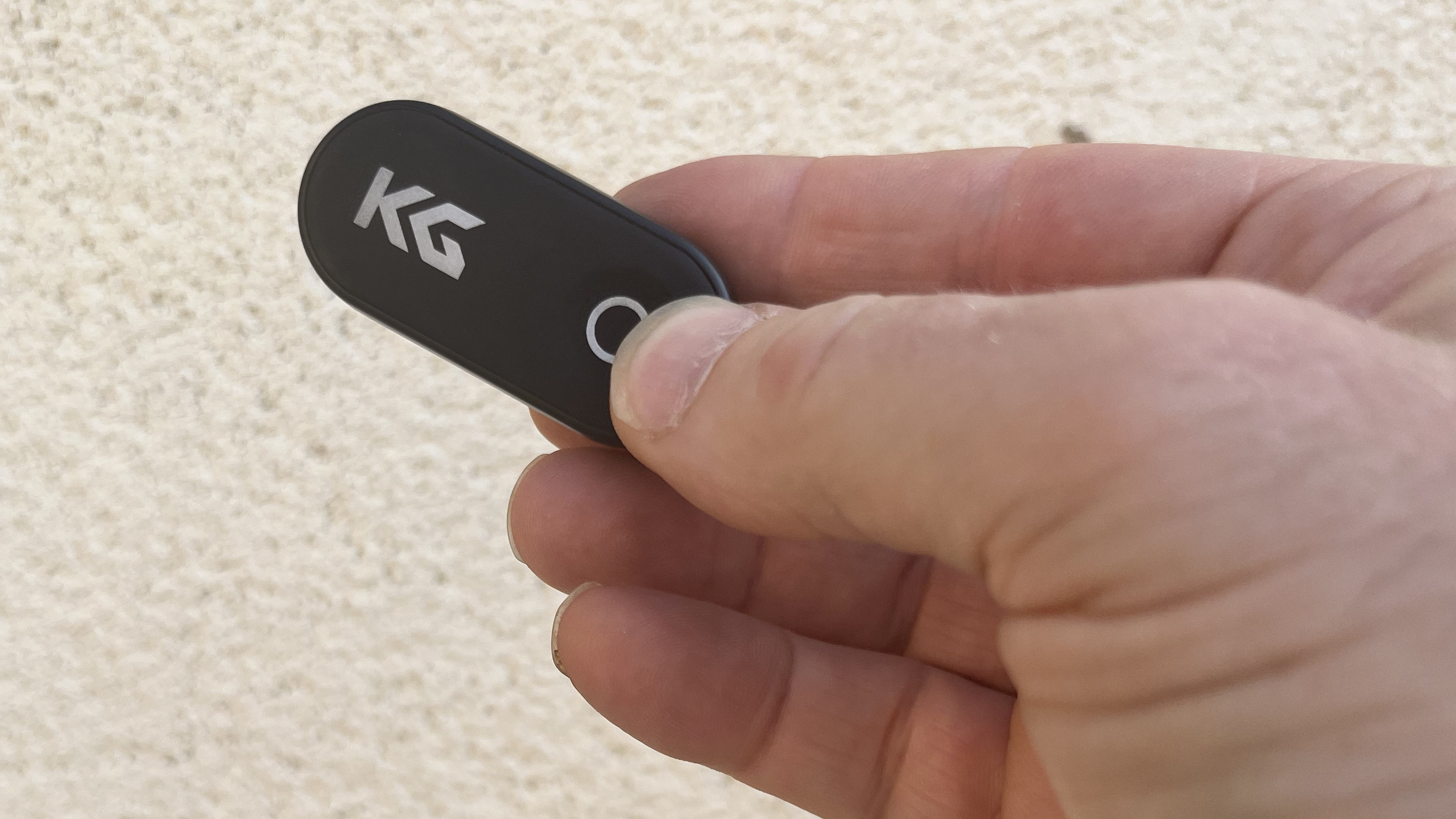 KraftGeek JustTap Magnetic Phone Tripod remote control in hand