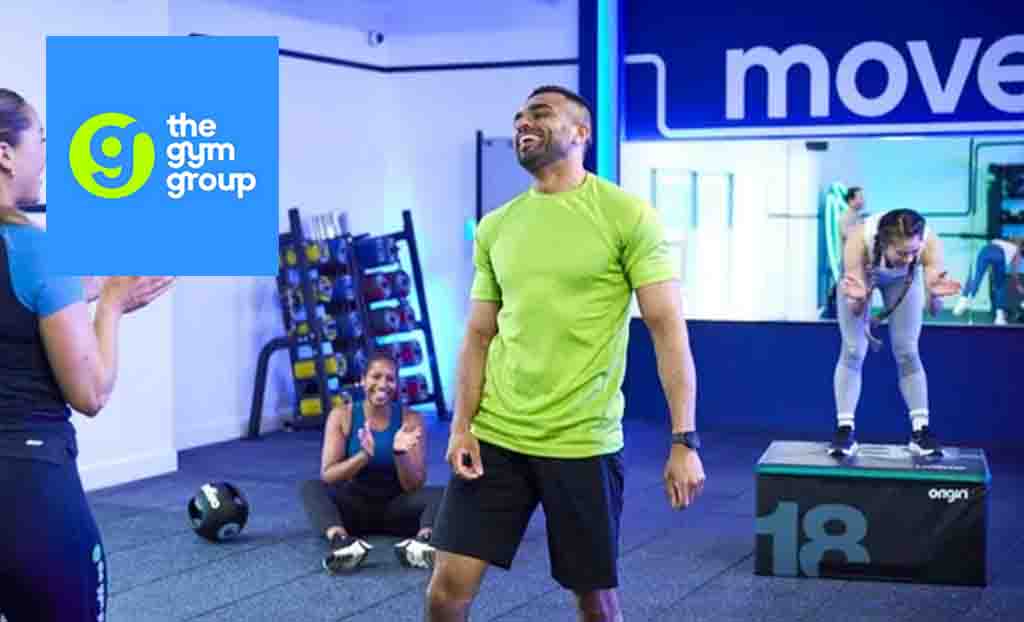 the gym group logo top left with a man in lime top smiling mid work out 
