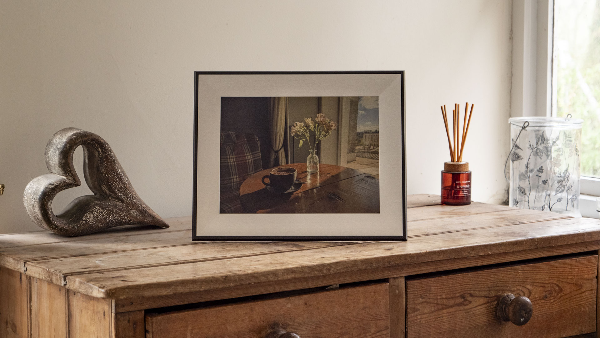 The Aura Ink 'E Ink' digital photo frame on a sideboard
