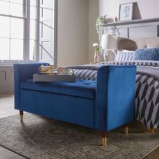blue sofa with white lamp and floor rug