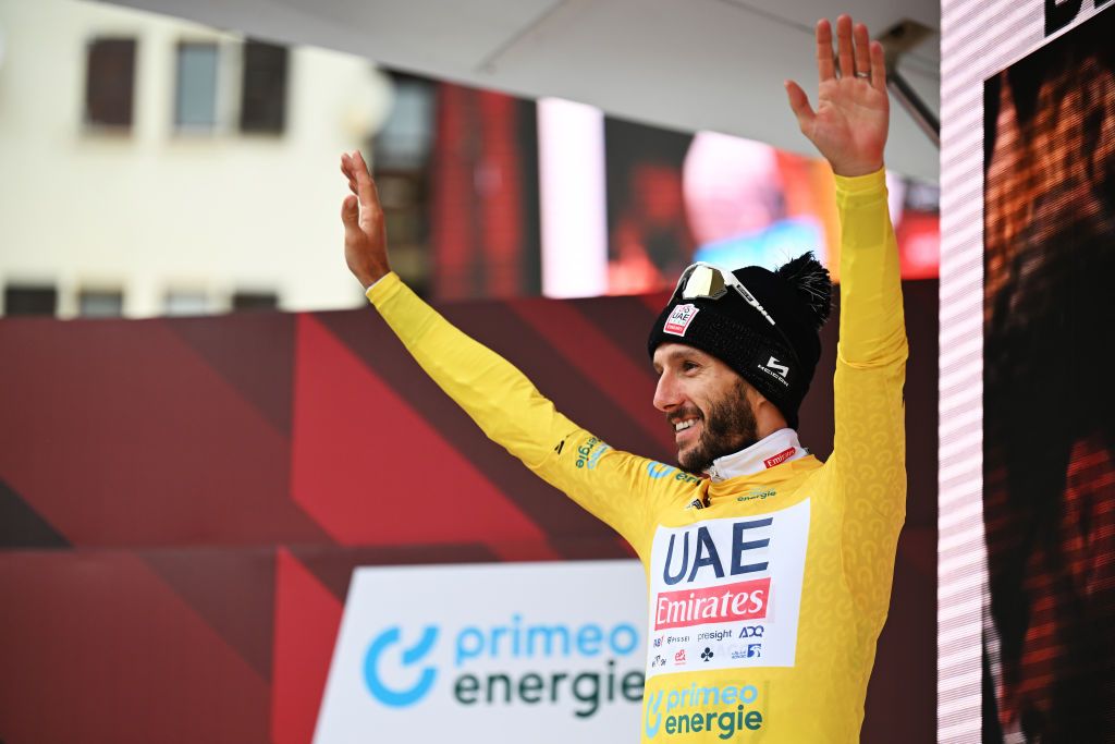 BLATTEN SWITZERLAND JUNE 14 Adam Yates of The United Kingdom and UAE Team Emirates celebrates at podium as Yellow leader jersey winner during the 87th Tour de Suisse 2024 Stage 6 a 425km stage from Ulrichen to Blatten 1330m UCIWT on June 14 2024 in Blatten Switzerland Photo by Tim de WaeleGetty Images