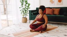 A woman practicing yoga at home