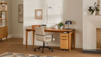 Wooden desk with white chair in living room