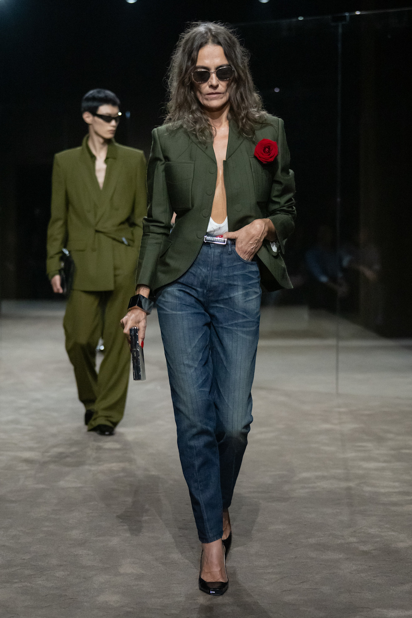 A model wears a rose pinned to the blazer at the tom ford show.