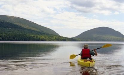 A man kayaks in Acadia National Park: The annual United State Peace Index ranks Maine as our nation's most peaceful state.