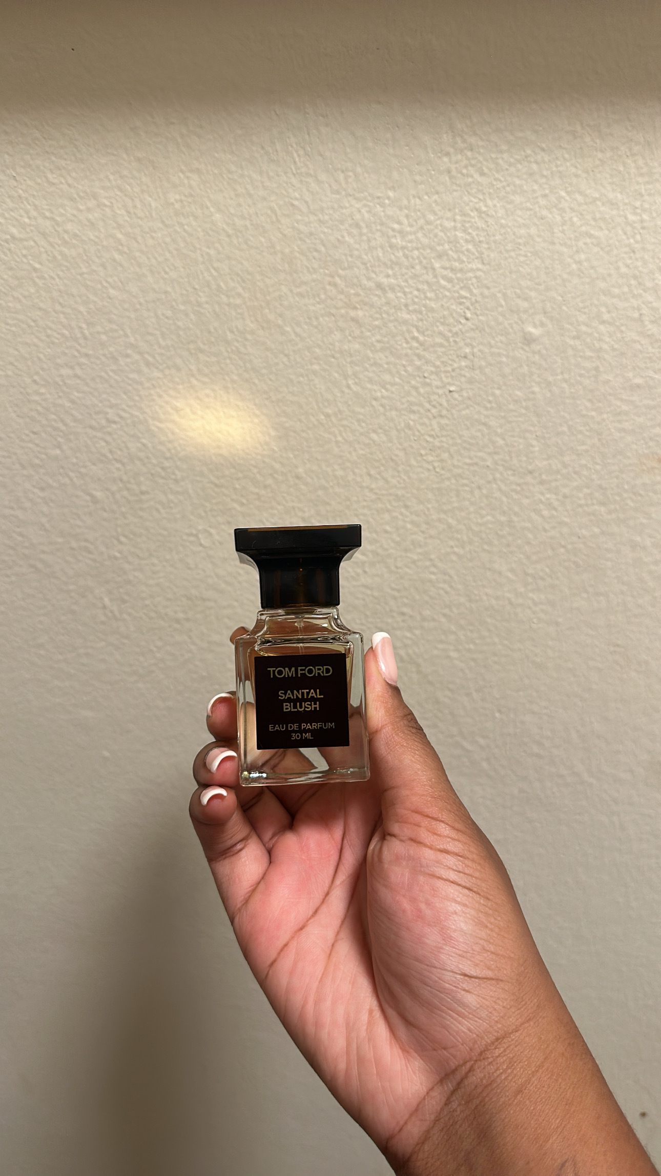 Ariel Baker testing Tom Ford Santal Blush perfume.