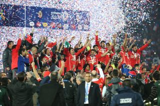 Chile players celebrate with the Copa America trophy after beating Argentina on penalties in the 2015 final in Santiago.