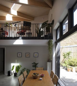 kitchen space with workspace mezzanine above in north London modern house
