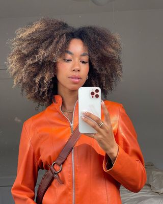 Content creator Amaka Hamelijnck poses with a bouncy, balayage curls