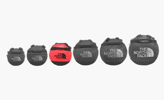Small Base Camp Duffel bags by The North Face. Round black and red duffel bags in six different sizes.