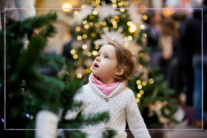 child looking at Christmas tree