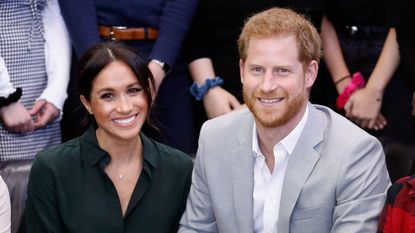 The Duke and Duchess of Sussex smile during an official visit to the Joff Youth Centre in Peacehaven, Sussex, in 2018