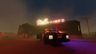 The glowing neon sign of Nell's Diner illuminates a small building, with an abandoned police car outside 