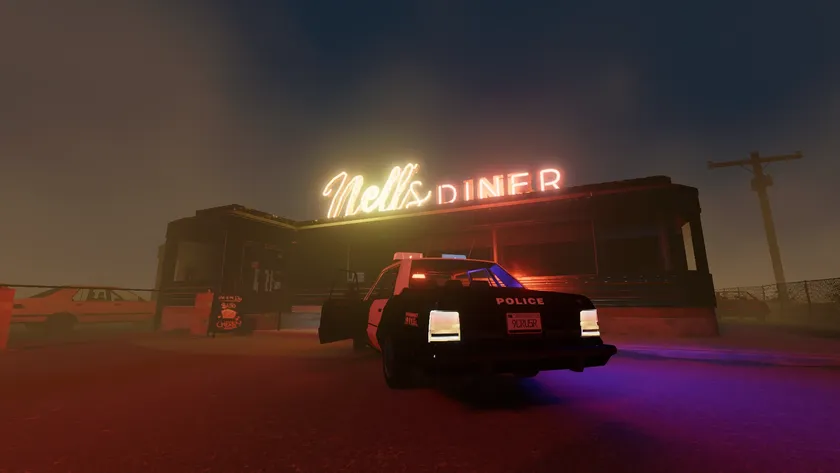 The glowing neon sign of Nell&#039;s Diner illuminates a small building, with an abandoned police car outside 