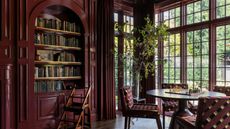 library room with large windows color-drenched berry red in gloss paint