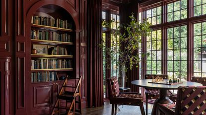 library room with large windows color-drenched berry red in gloss paint