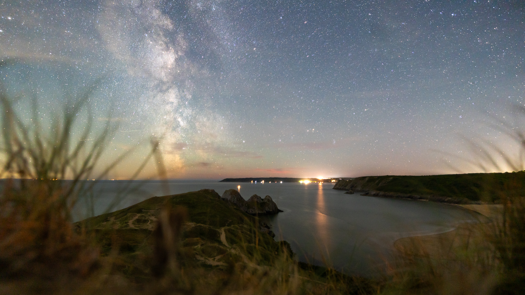 milky way above three cliffs bay in south wales