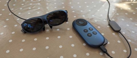 The Rokid Max AR glasses connected to the Rokid Station via a cable while they sit on a polka dot covered table