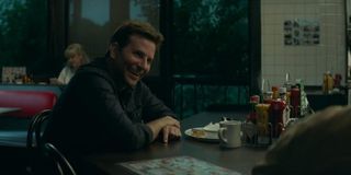 The Mule Bradley Cooper smiles and laughs at a diner counter