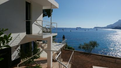 A view of E-1027 with a newly installed bust of Eileen Gray by contemporary artist Vera Klute. A view of the ocean from the side of the villa.