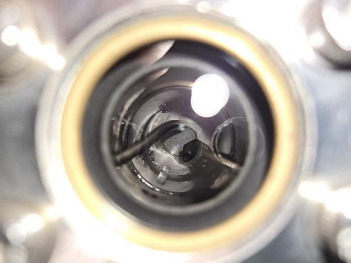 grey dust in the bottom of a clear glass cylinder