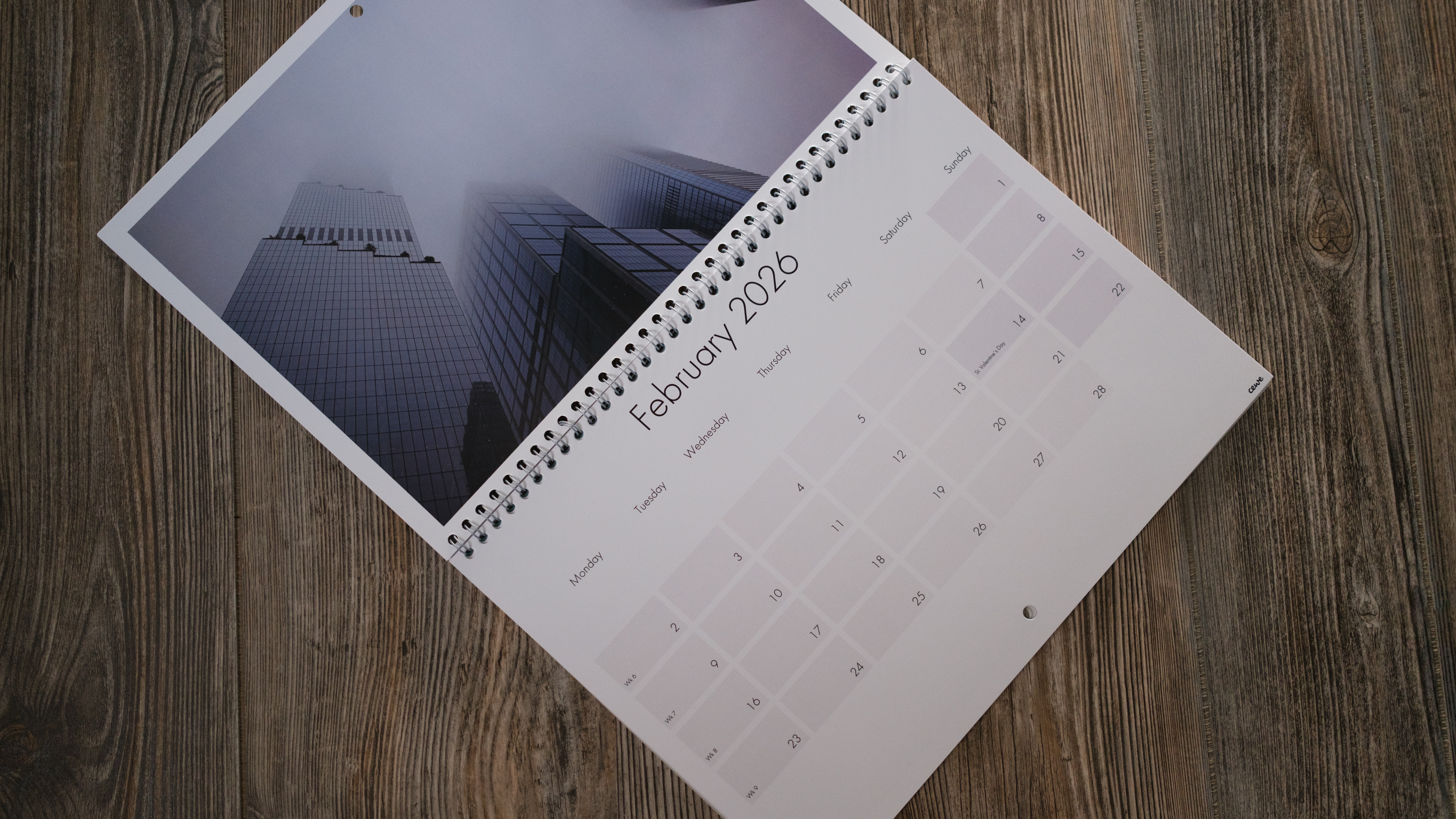 A photo calendar from CEWE on a wood background