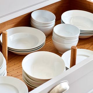 bowl and plates in wooden drawer
