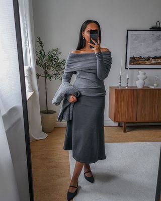 12 Scandi Outfit Ideas: Lydia wears an off-the-shoulder jumper with an A-line midi skirt.