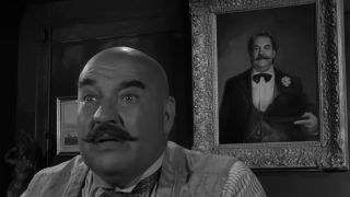 A man with a mustache standing in front of a painting of a similar looking man in The Twilight Zone episode Mr. Garrity And The Graves