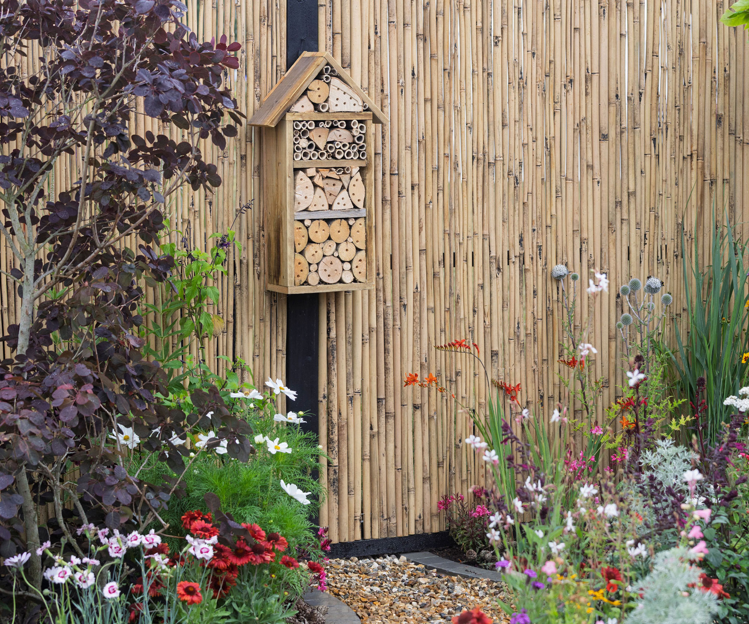 pollinator garden with insect hotel and wildlife friendly planting