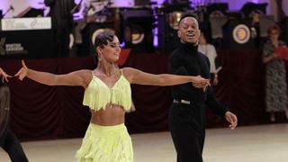Blackpool's Dance Fever - Lauren Claydon in a lime beaded dress and Oskar Odiakosa in a black top and trousers on the dance floor as they take part in the Blackpool Dance Festival.
