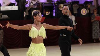 Blackpool&#039;s Dance Fever - Lauren Claydon in a lime beaded dress and Oskar Odiakosa in a black top and trousers on the dance floor as they take part in the Blackpool Dance Festival.