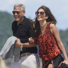 Amal Clooney wearing a beaded top with a mini skirt and boots in Saint-Tropez
