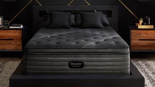 The Beautyrest Black K-Class Plush Pillow Top mattress in a bedroom