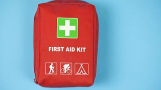 First aid kit on blue background