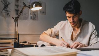 An artist practices drawing using one of the best drawing books