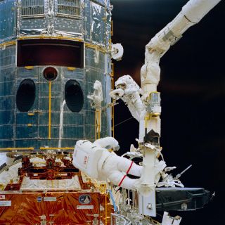 NASA astronauts install a new camera on the Hubble Space Telescope during its first servicing mission in 1993.